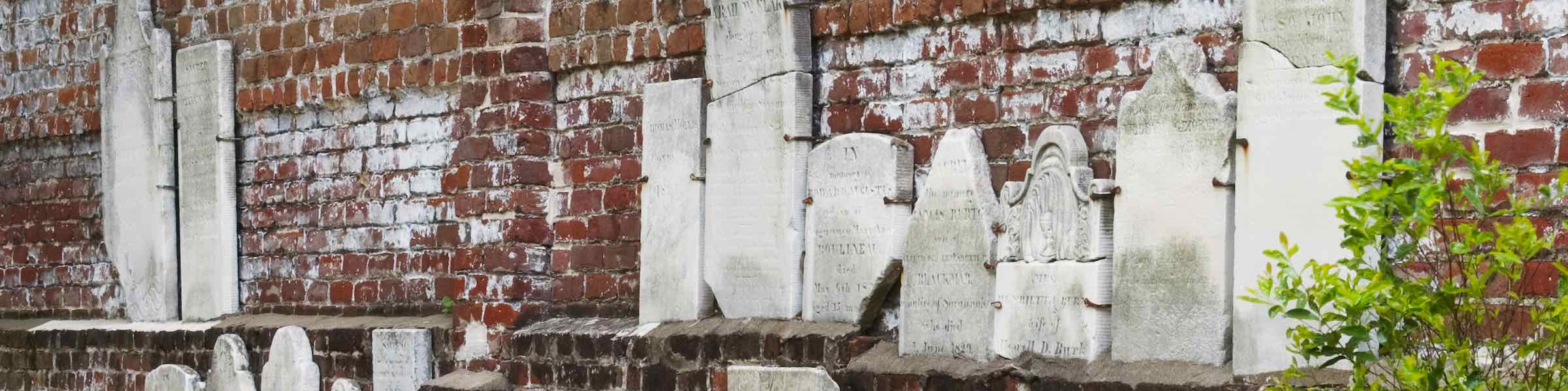 Grave stones mounted on the rear wall in Savannah's Colonial Park Cemetery.