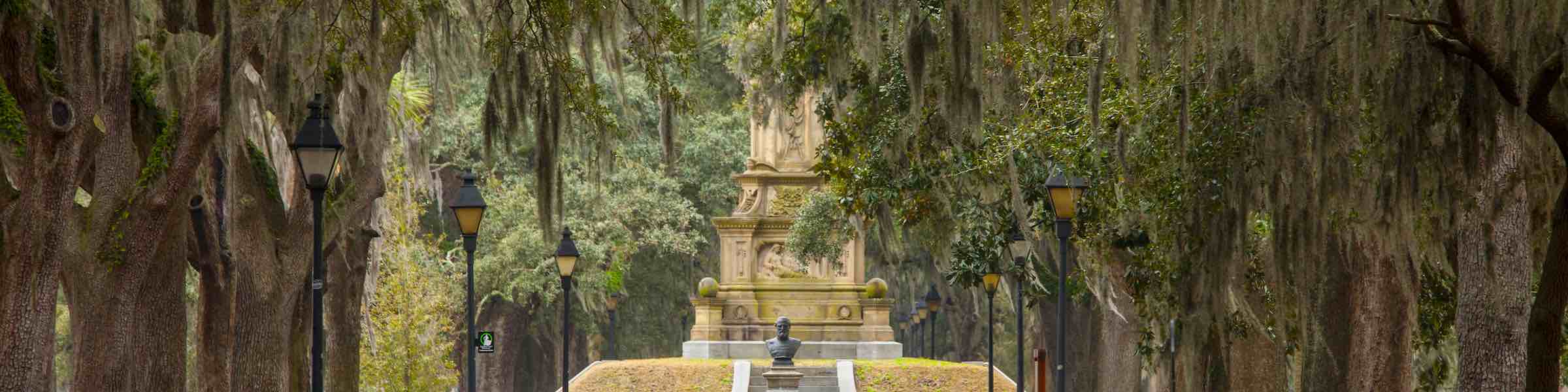 The Confederate Memorial in Forsyth Park, Savannah, GA, seen through moss-covered live oaks.