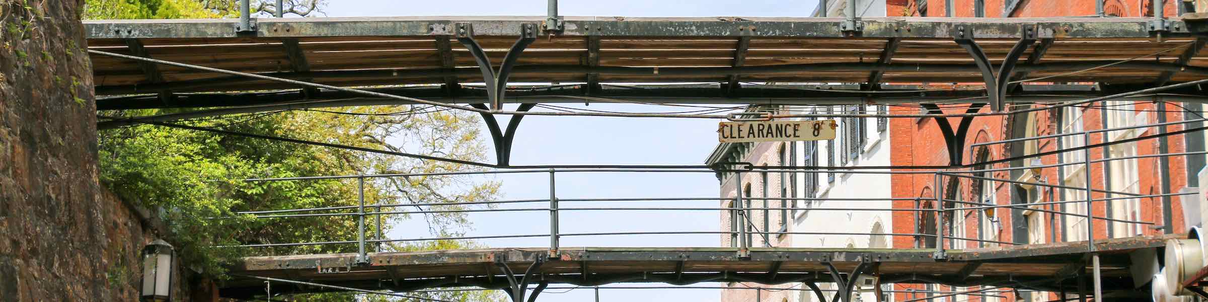 Footbridges connecting old warehouse buildings to Bay Street along Savannah's Factors Walk.