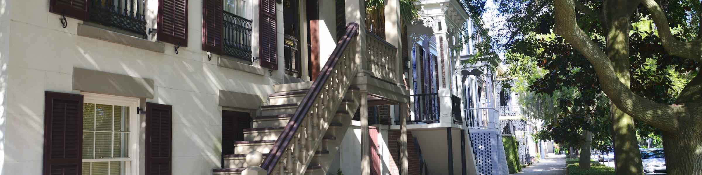 A view of historic houses along a street in Savannah's Historic District.