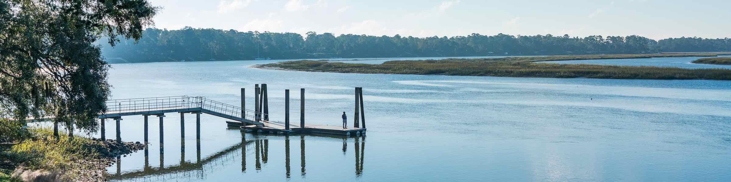 A man standing on a jetty at the May River, Bluffton, SC.