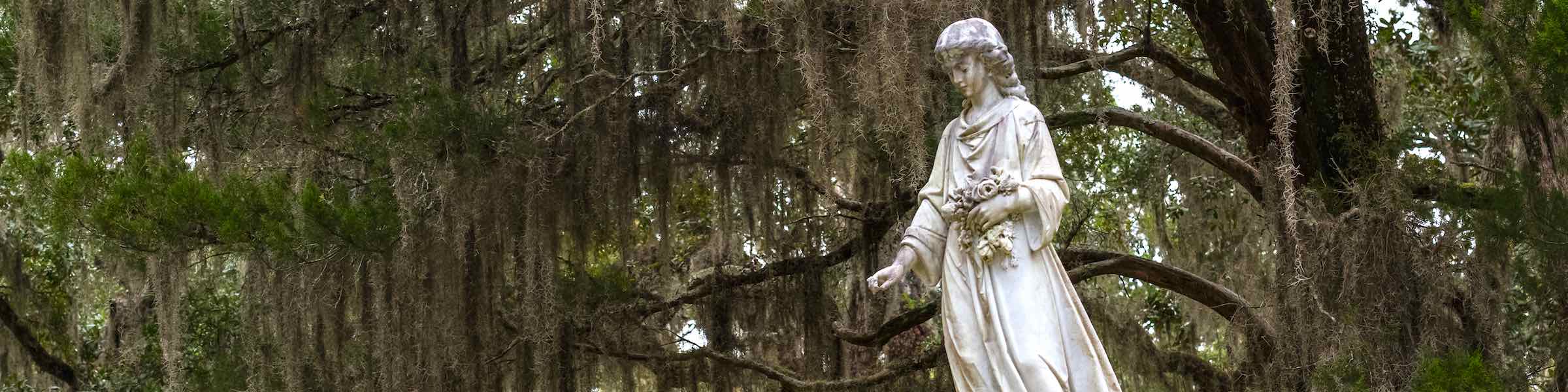 Statue depicting a standing woman in a historic Savannah, GA cemetery.